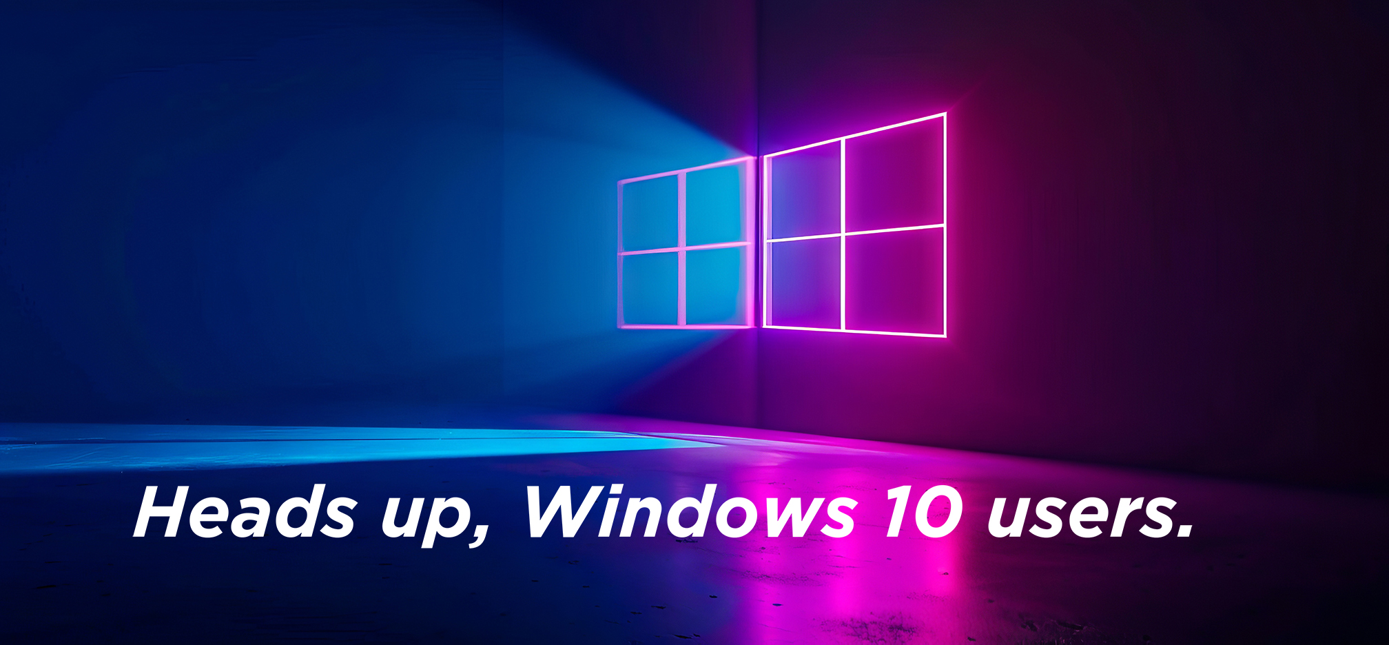 A dark, modern-looking image with a neon outline of the Windows logo glowing on a wall in pink and blue light. The neon light casts a vivid blue and purple glow onto the floor and walls of the room. Large white bold text at the bottom says: “Heads up, Windows 10 users.” The visual suggests an alert or important message specifically for people using Windows 10.